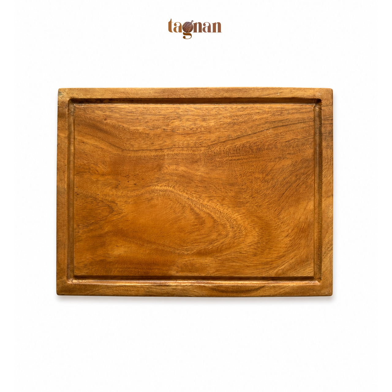 A rectangular wooden cutting board with a raised border, showcasing a warm brown wood grain pattern, presented on a clean white background with the tagnan brand logo above.