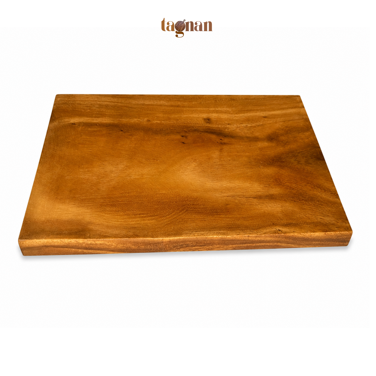 A rectangular wooden cutting board with a live edge and rich warm brown wood grain, shown from a high angle on a white background with the tagnan brand logo above.